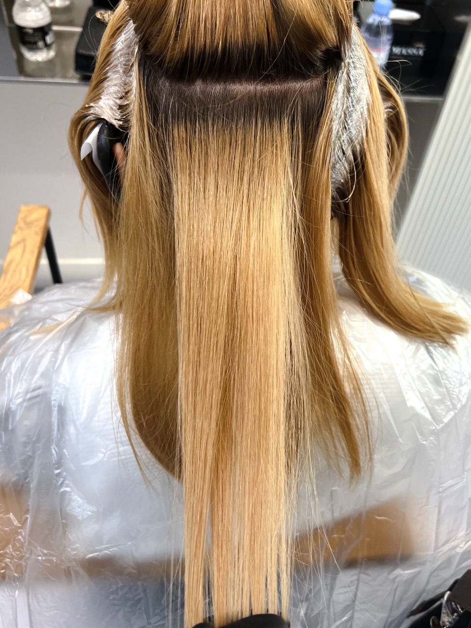 Client C before colour correction, sectioned to show multiple bands of warm blonde colour