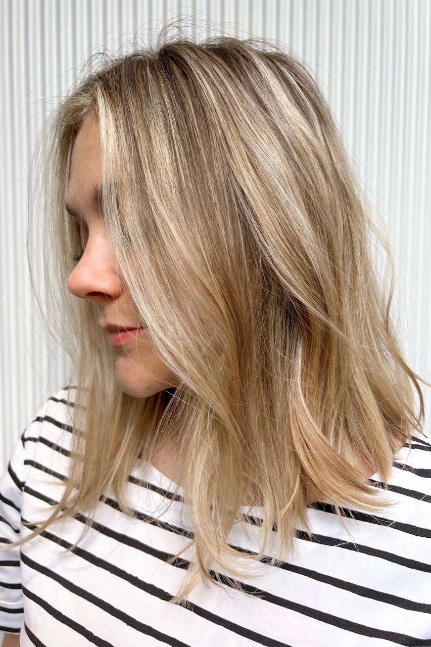 Client B after sunkissed balayage with brighter face-framing pieces and a natural blonde finish