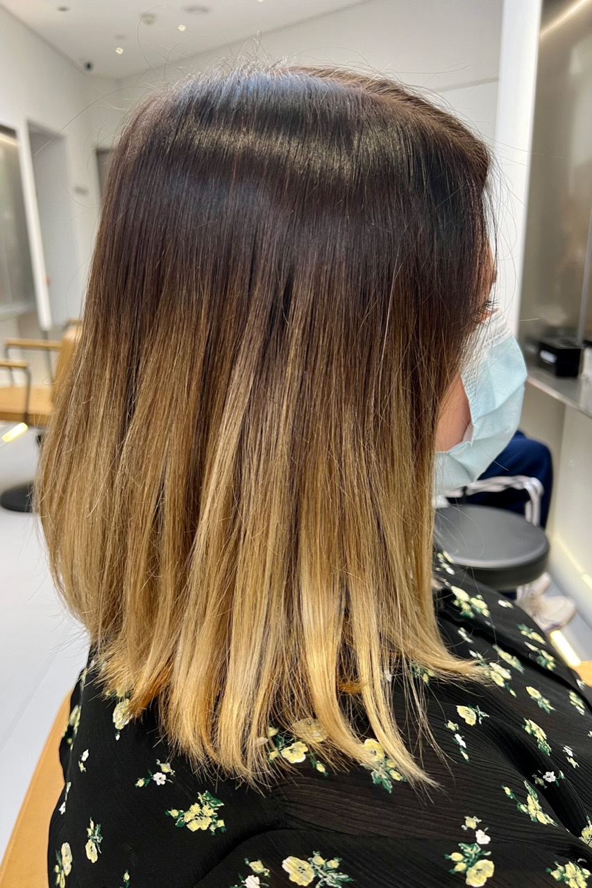 Client C before balayage with dark regrowth, yellowed blonde lengths and dry-looking ends