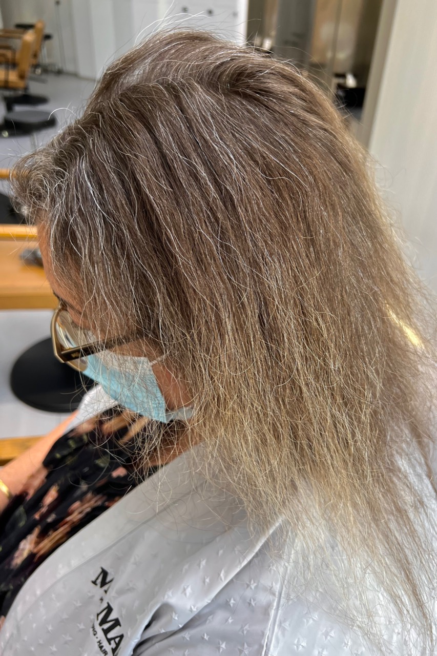 Before grey transition showing uneven white and deeper blonde-grey zones after four months of grow-out